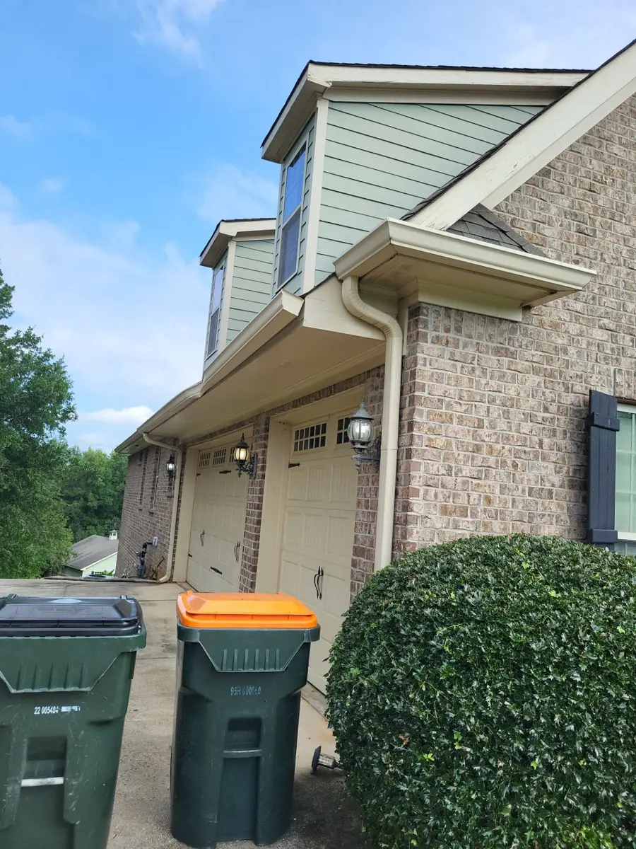 House side showing roof edge, gutters, downspouts, and exterior wall, Southern Premier Roofing work near Bethlehem GA