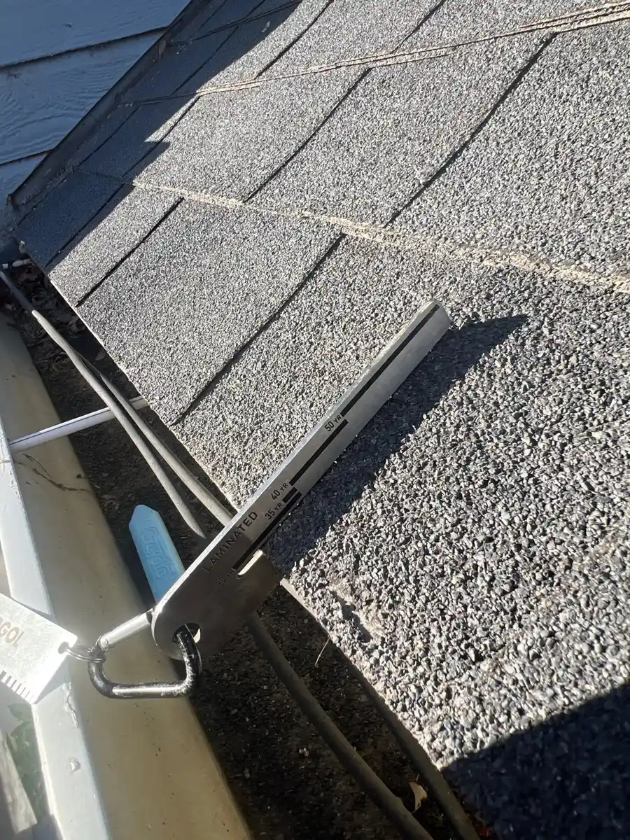Roof shingles meeting gutter with visible drainage hardware, Southern Premier Roofing work near Bostwick GA