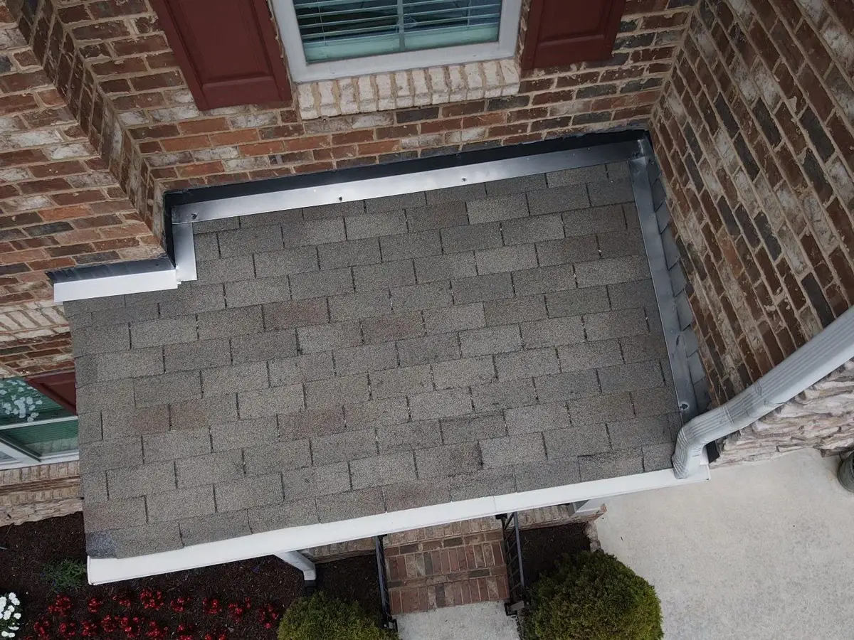 Small shingled roof section between brick walls and gutters, Southern Premier Roofing work near Talmo GA