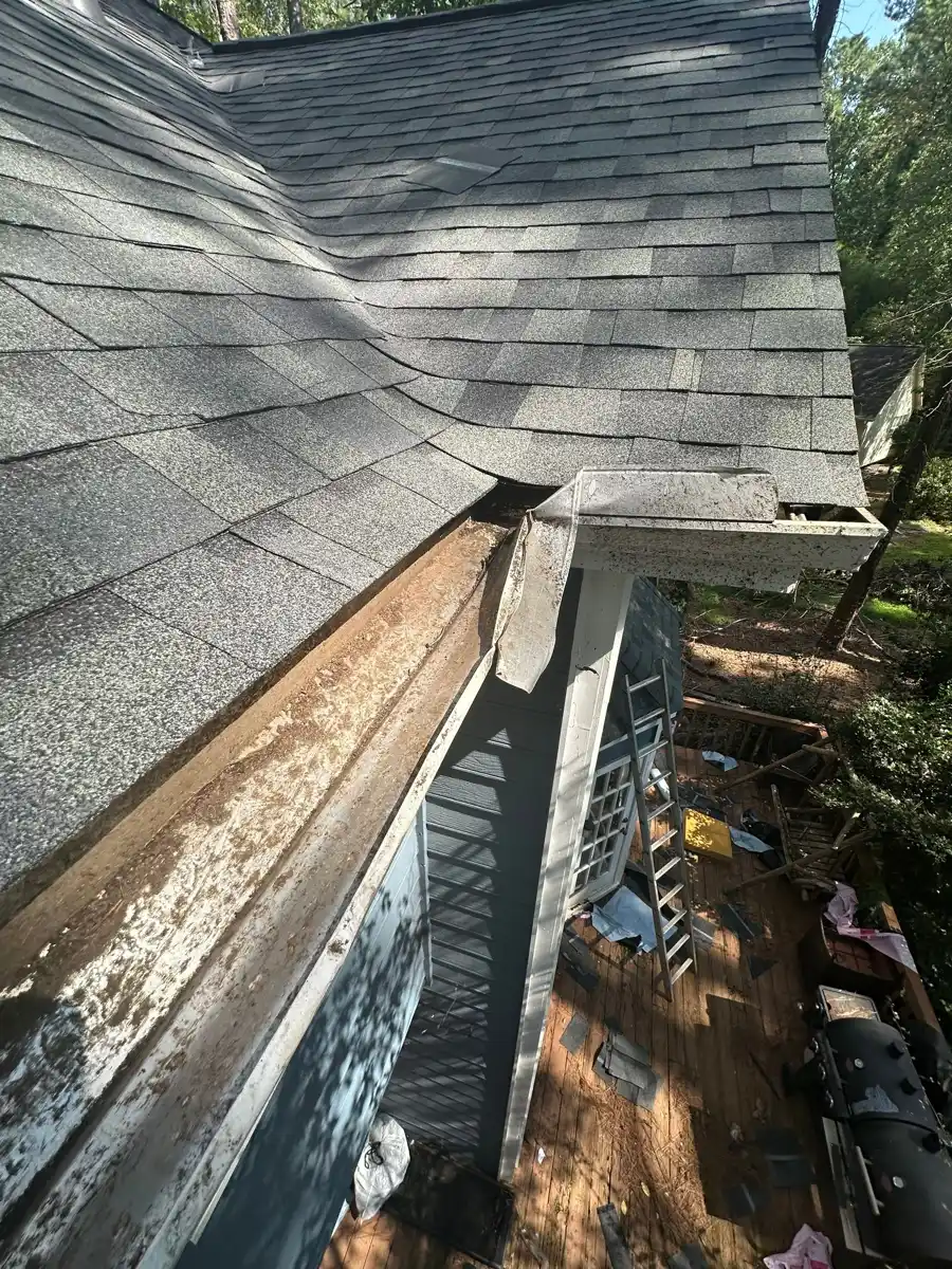 Roof edge with shingles, exposed gutter, and debris below, Southern Premier Roofing work near Lula GA