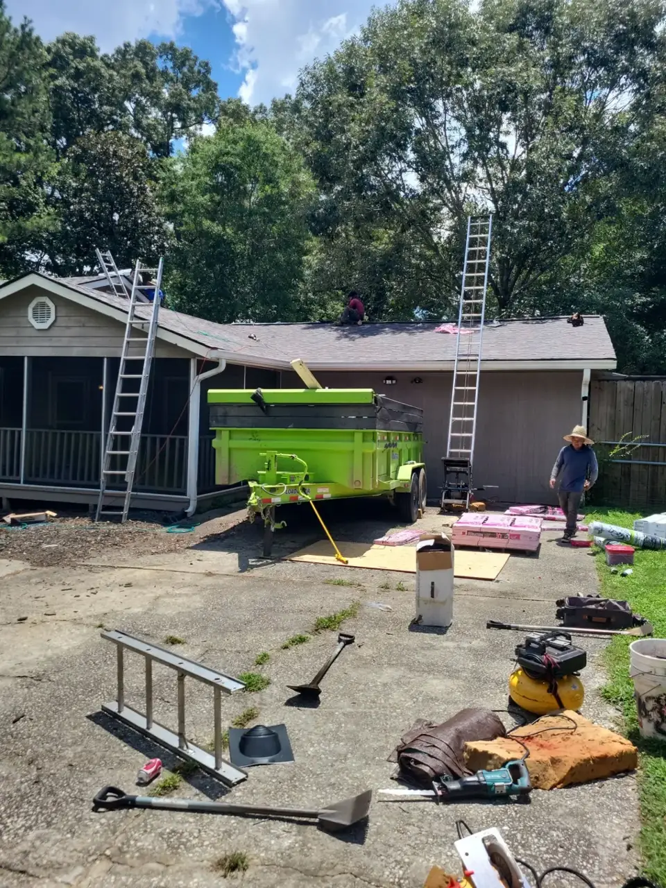 Roof replacement scene with ladders, green dumpster, tools, and shingle materials