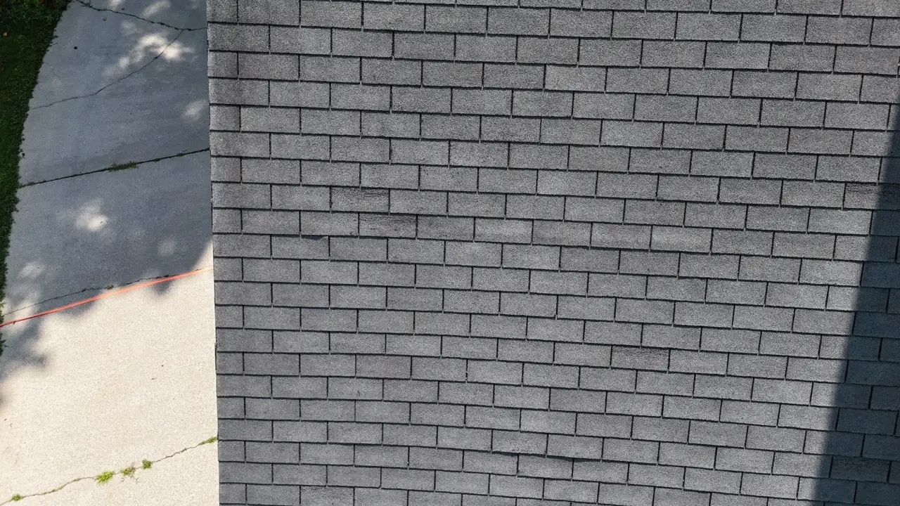 Gray shingle roof viewed above a concrete driveway in Decatur GA