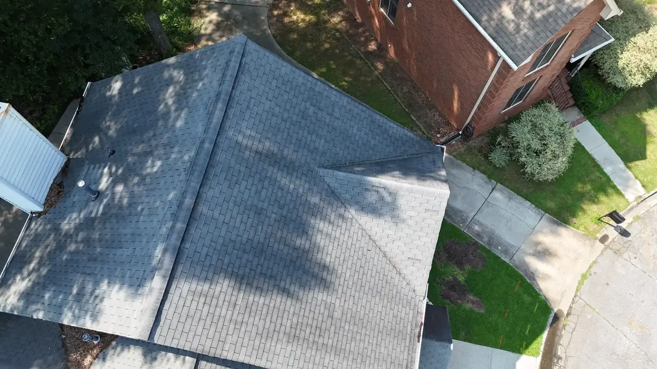 Aerial view of gray shingle residential roof beside a brick home in Decatur GA
