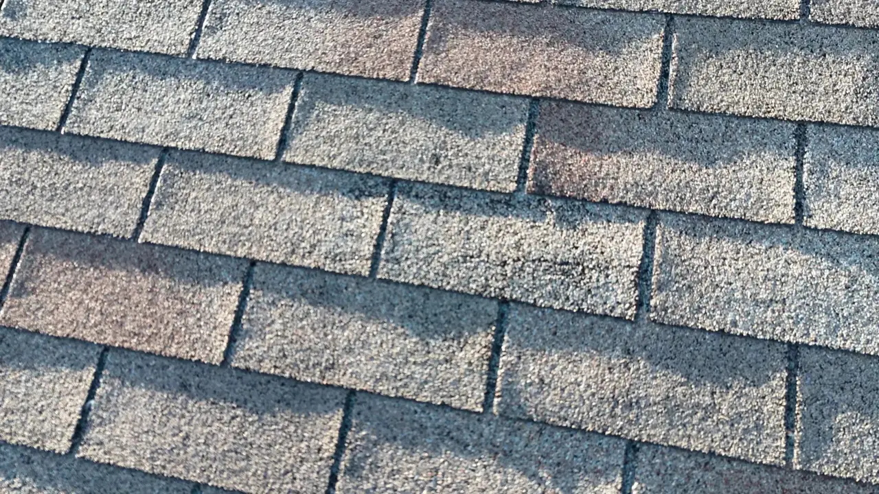 Close-up view of textured, weathered asphalt roof shingles
