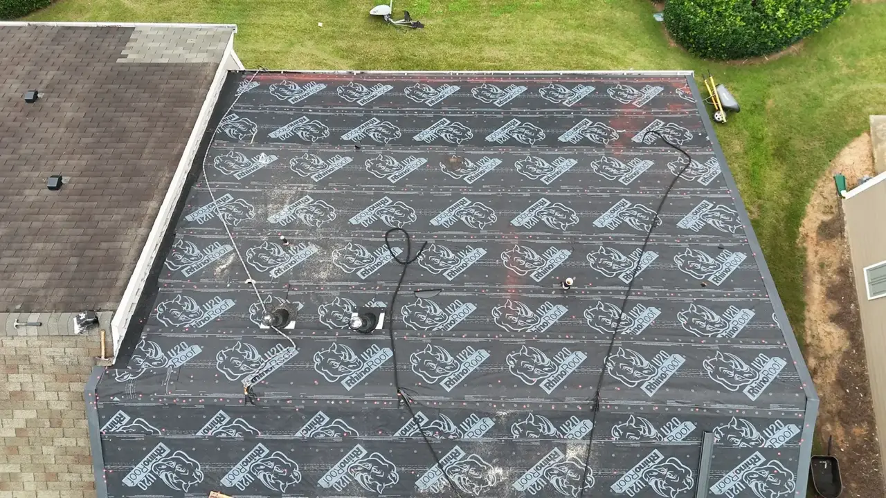 Aerial view shows roof covered with branded black underlayment beside an existing shingled roof in Duluth GA.