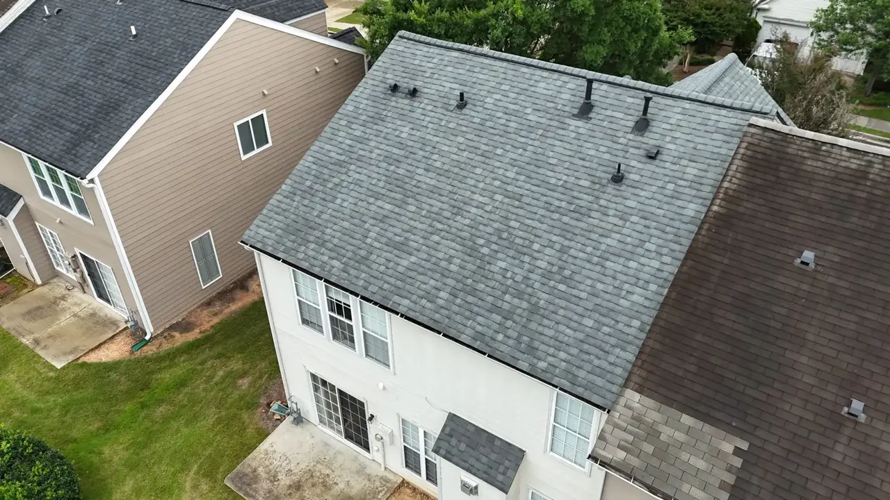 Aerial view of residential gray shingle roof beside neighboring homes in Duluth, GA