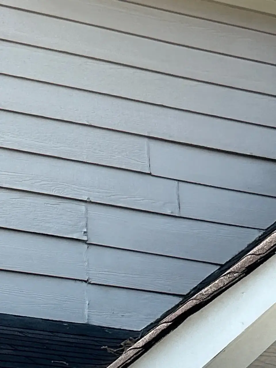 Close-up of gray horizontal siding and roof edge on a residential home in Kennesaw, GA
