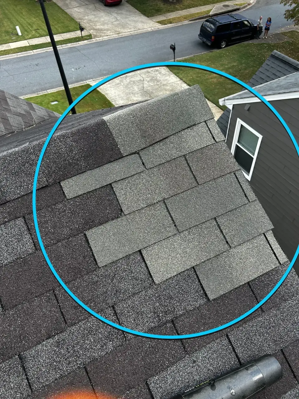 Gray shingle roof section above siding and driveway, photographed in Kennesaw GA.