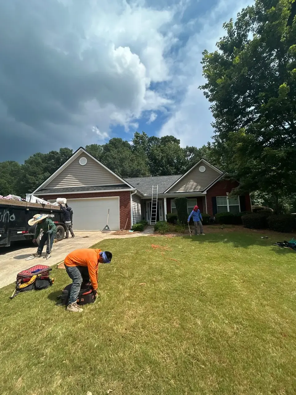 Roofing crew and equipment outside a brick-and-siding home in Loganville, GA.