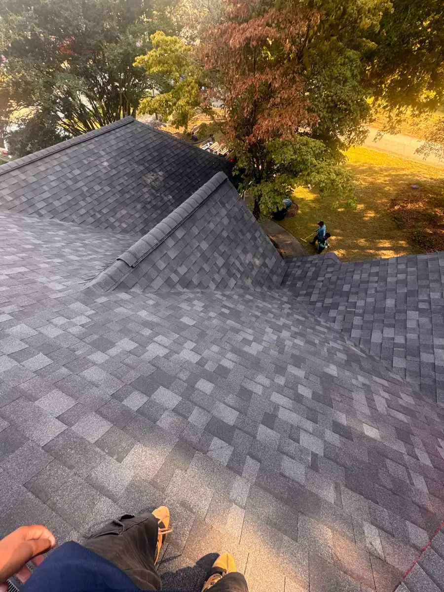 Completed shingle roof with ridge vent and surrounding trees, Southern Premier Roofing work near Arcade GA