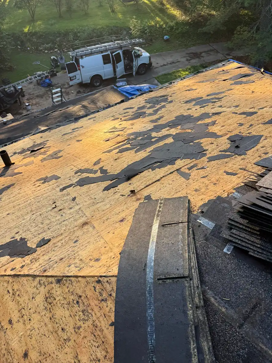 Roof stripped to decking with removed shingles stacked nearby, Southern Premier Roofing work near Arcade GA