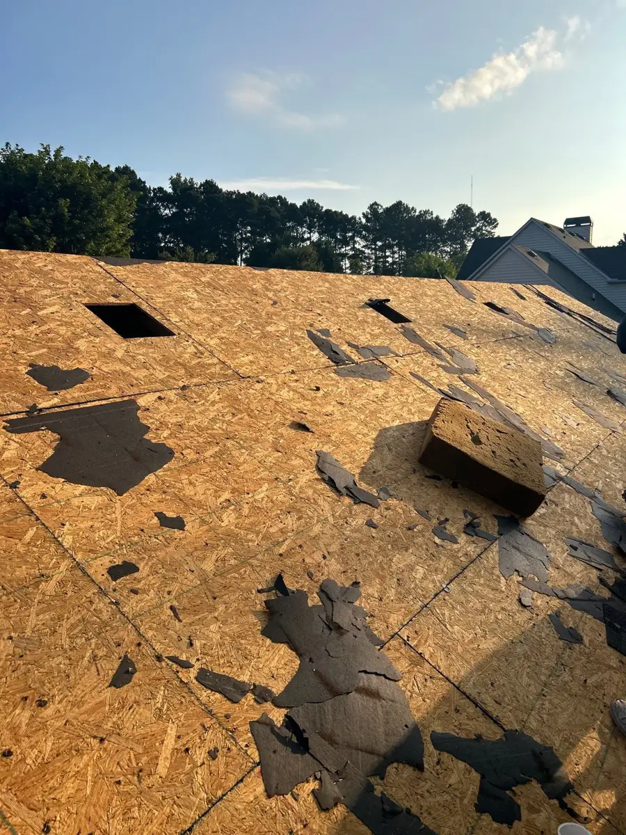 Roof deck exposed with scattered remnants of torn roofing material, Southern Premier Roofing work near Arnoldsville GA