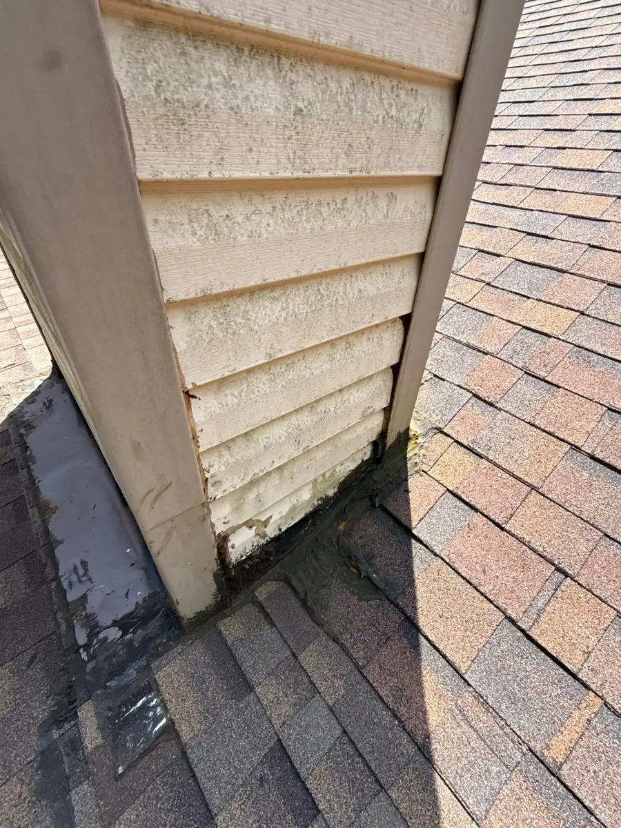 Roof flashing detail beside siding and adjacent shingle slope, Southern Premier Roofing work near Arnoldsville GA