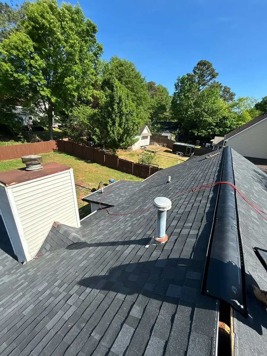 Completed shingle roof with vents, ridge cap, and clean installation, Southern Premier Roofing work near Auburn GA