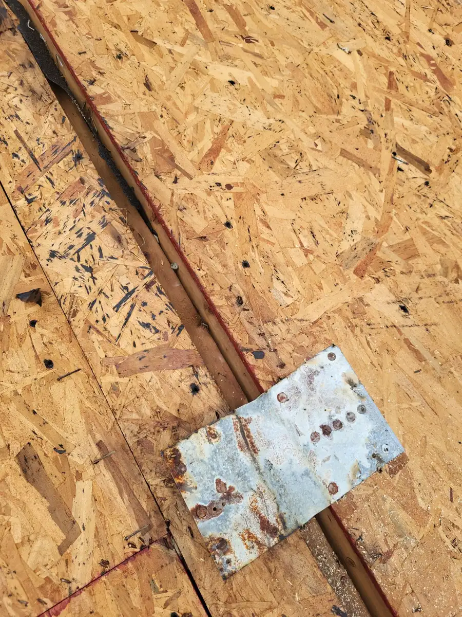 Metal flashing piece positioned over exposed roof decking, Southern Premier Roofing work near Auburn GA
