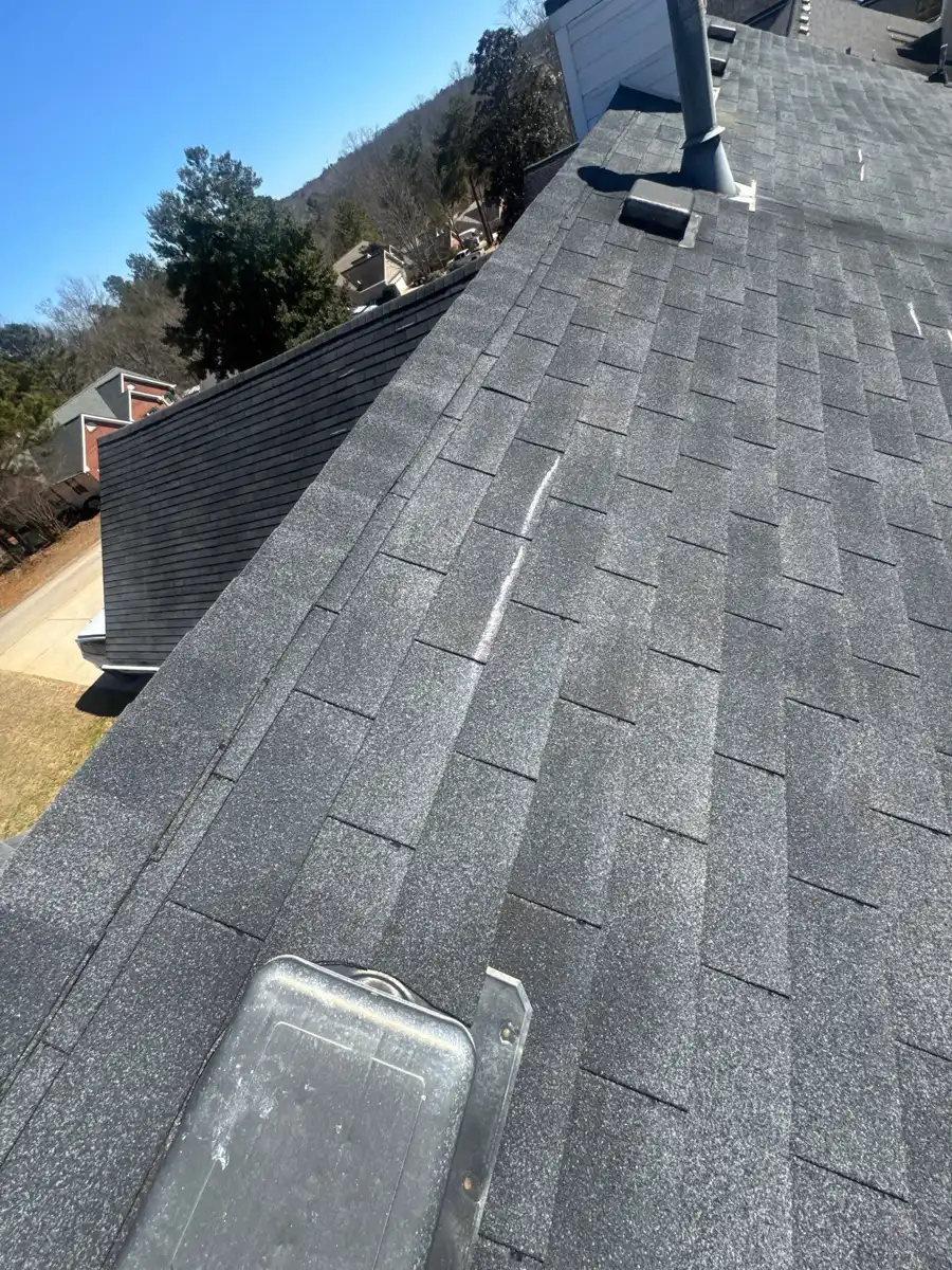 Gray shingle roof with skylight, ridge, and chimney visible, Southern Premier Roofing work near Bethlehem GA