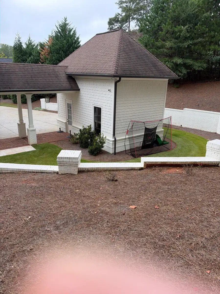 Completed brown roof and landscaped patio viewed from elevated angle, Southern Premier Roofing work near Bostwick GA