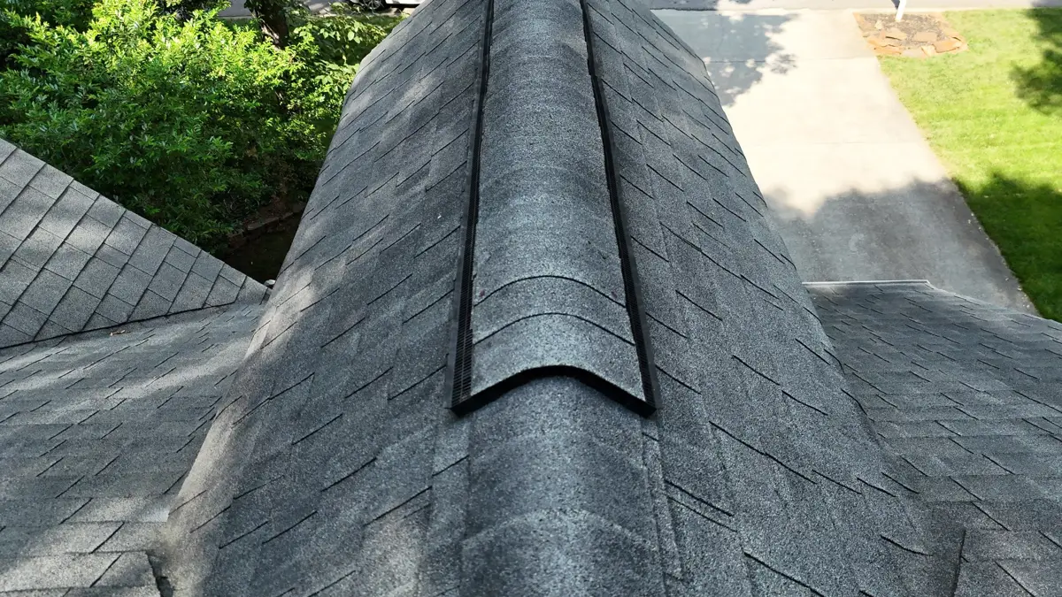 Close view of ridge vent installed along shingled roof peak, Southern Premier Roofing work near Bostwick GA