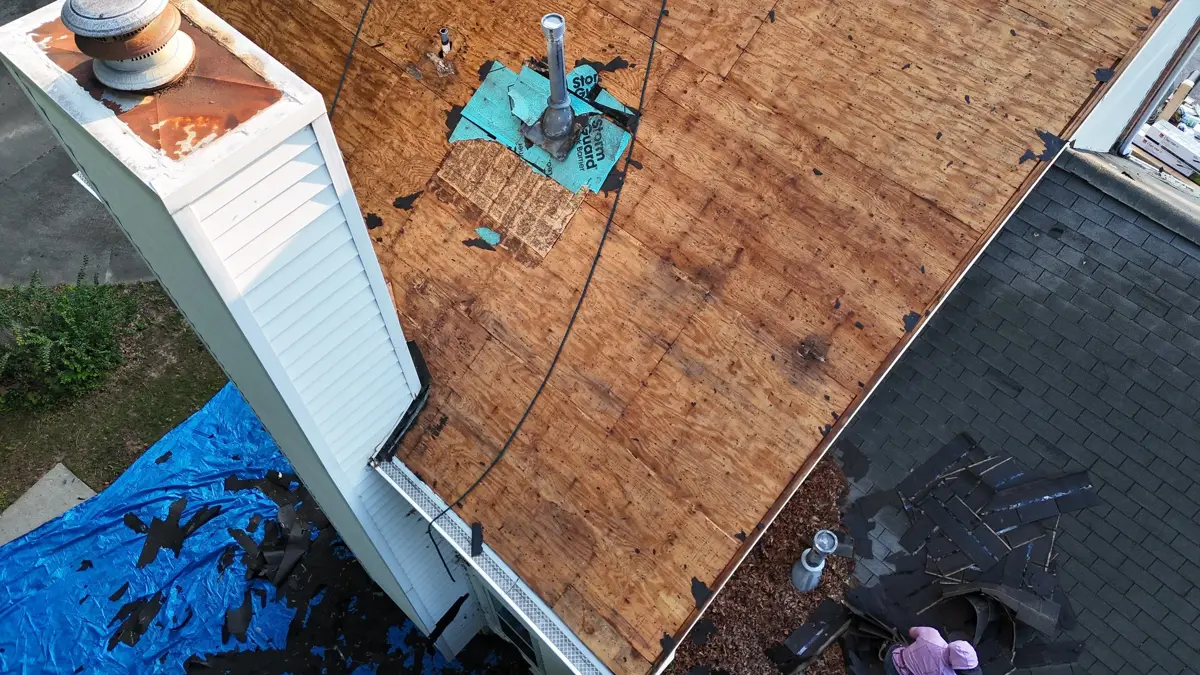 Exposed plywood roof decking with chimney and rooftop equipment, Southern Premier Roofing work near Braselton GA
