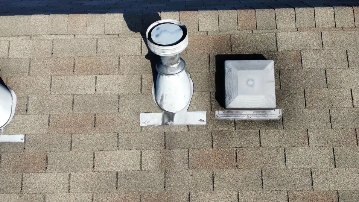Roof vent and flashing surrounded by weathered asphalt shingles, Southern Premier Roofing work near Buford GA
