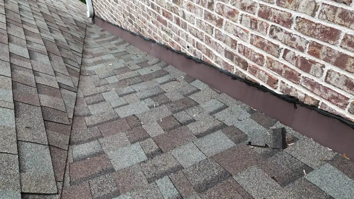 Roof valley flashing detail along brick wall edge, Southern Premier Roofing work near Carl GA
