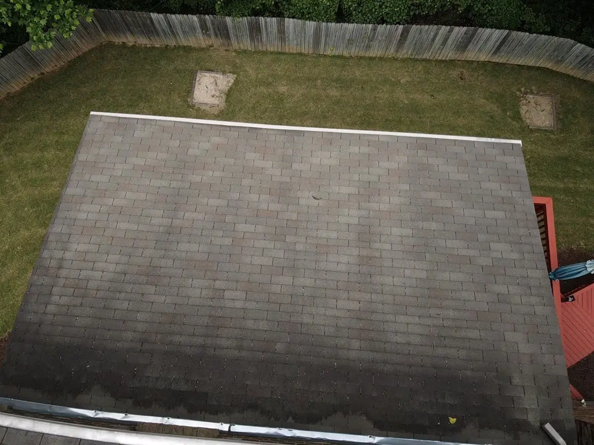 Aerial view of completed rectangular shingle roof beside fenced yard, Southern Premier Roofing work near Colbert GA