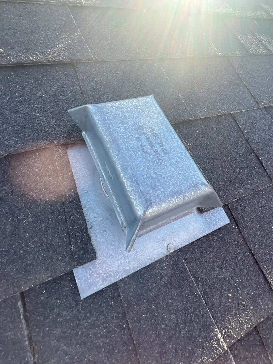 Metal roof flashing detail installed among asphalt shingles, Southern Premier Roofing work near Covington GA