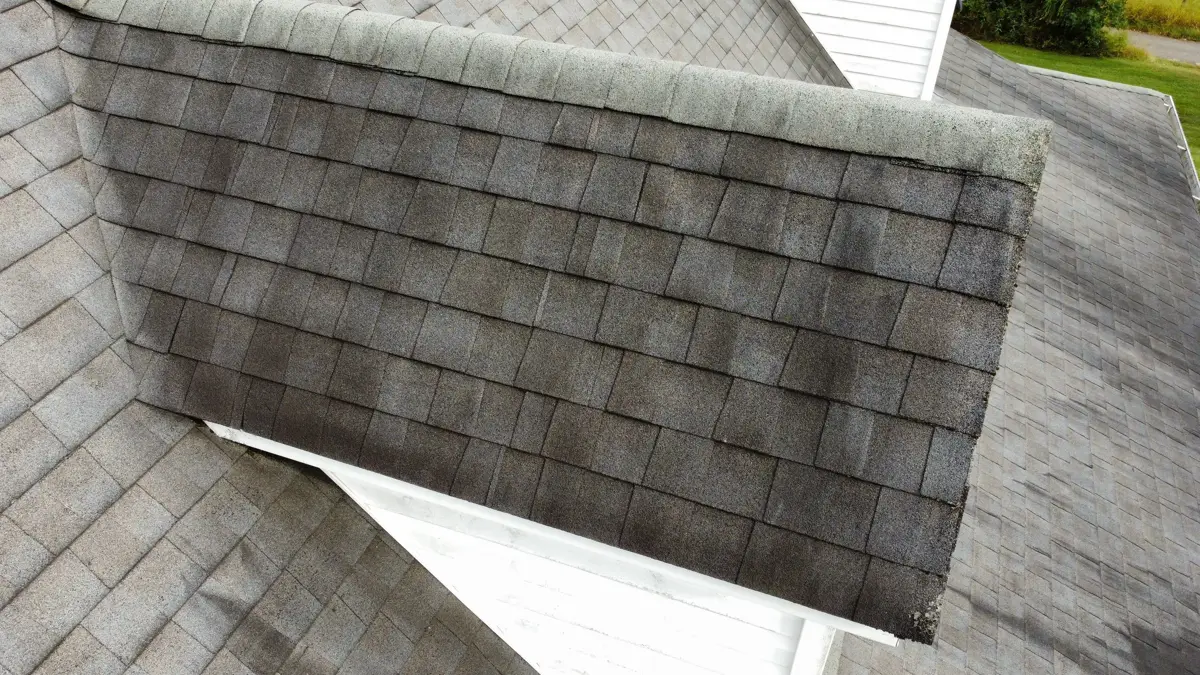 Close view of weathered gray shingles on intersecting roof sections, Southern Premier Roofing work near Cumming GA