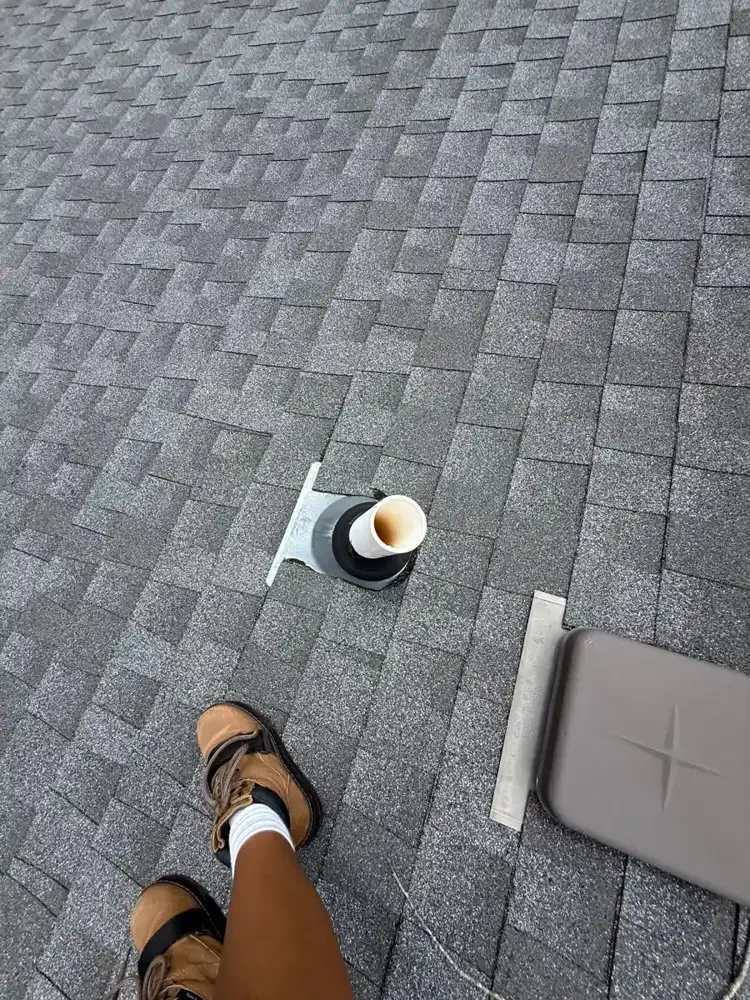 Roof surface with circular vent opening and ridge vent materials, Southern Premier Roofing work near Cumming GA