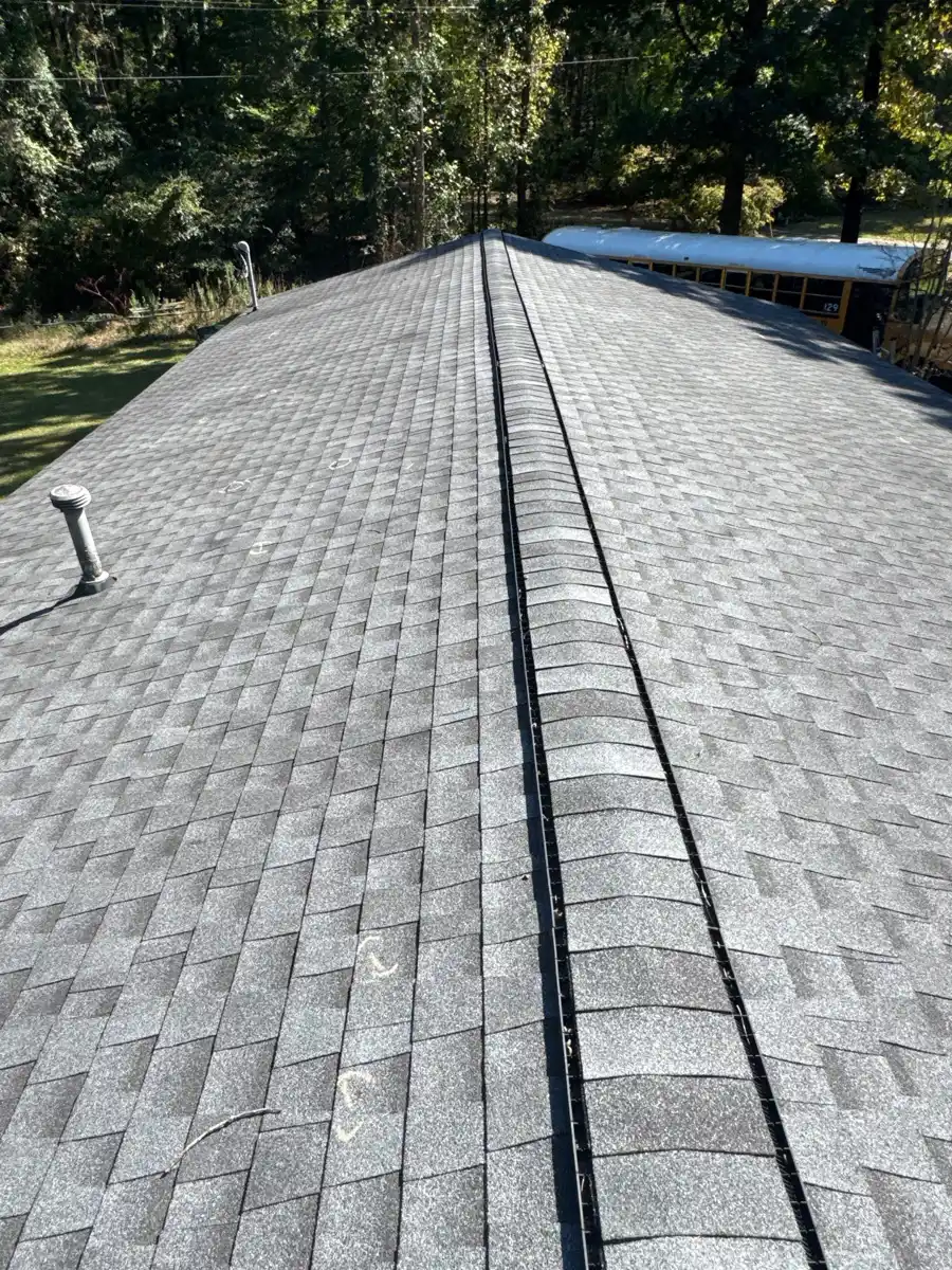 Long roof ridge with continuous ridge vent and surrounding shingles, Southern Premier Roofing work near Cumming GA