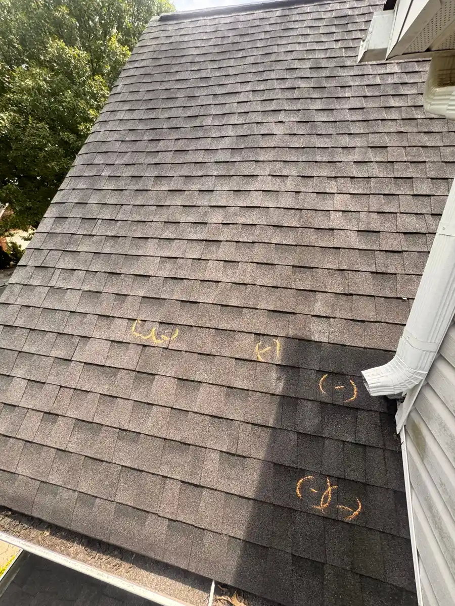 Aged shingle roof with gutter and visible surface markings, Southern Premier Roofing work near Dacula GA