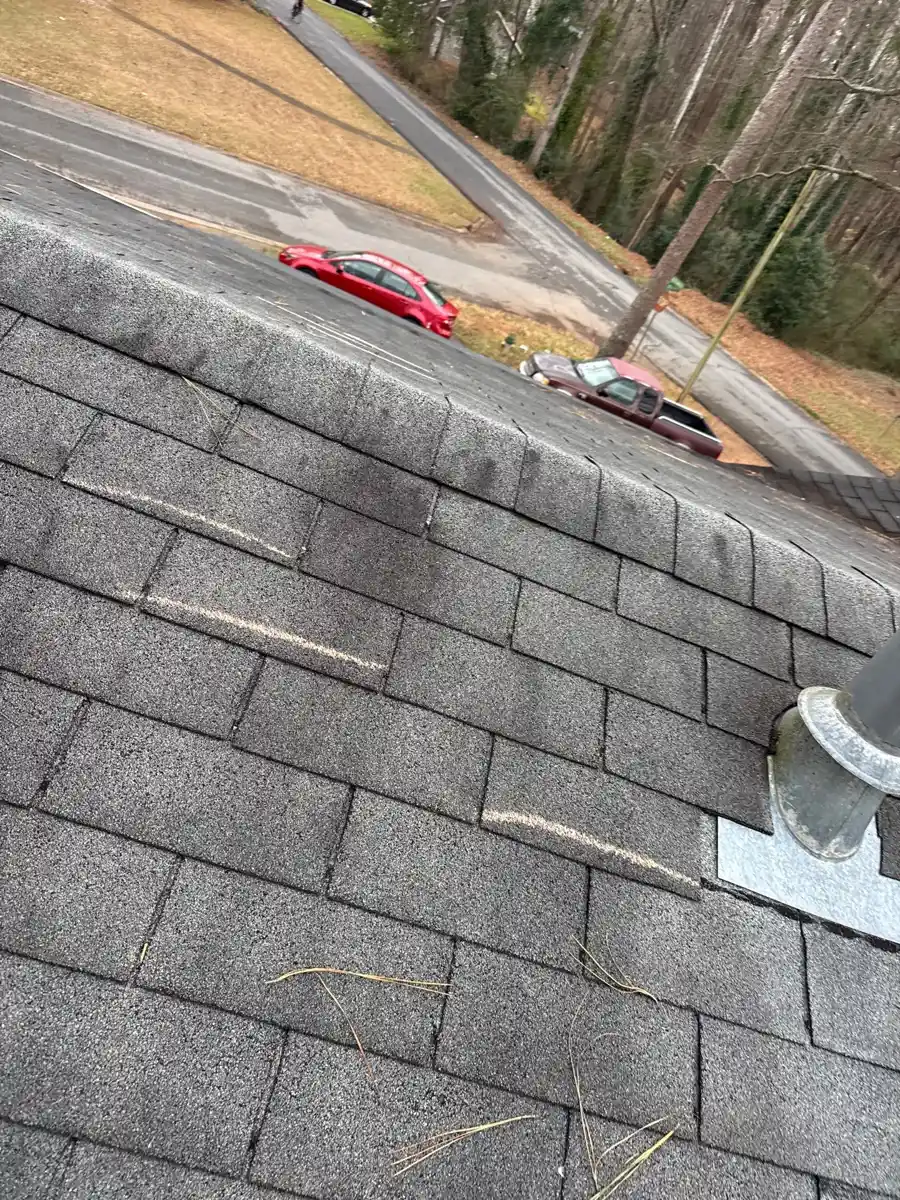 Roof shingles and vent flashing beside visible driveway, Southern Premier Roofing work near Dacula GA