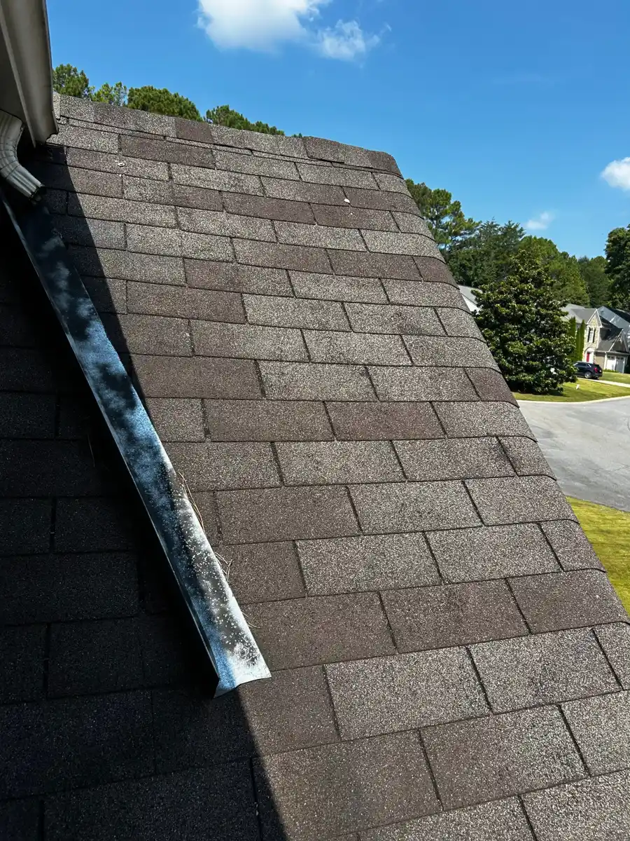 Roof slope shows exposed metal flashing along a side edge, Southern Premier Roofing work near Gainesville GA