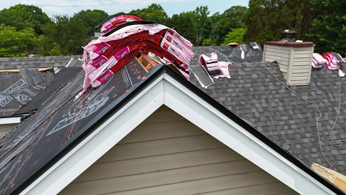 Roof ridge with bundled shingles staged above front gable, Southern Premier Roofing work near Gillsville GA