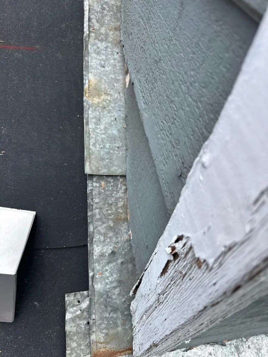 Close view of weathered flashing beside roof wall intersection, Southern Premier Roofing work near Good Hope GA