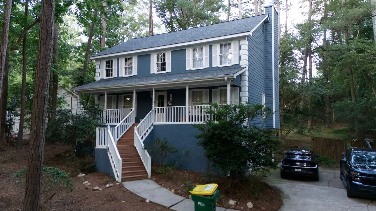 Completed residential home with gray shingle roof and landscaping, Southern Premier Roofing work near Grayson GA
