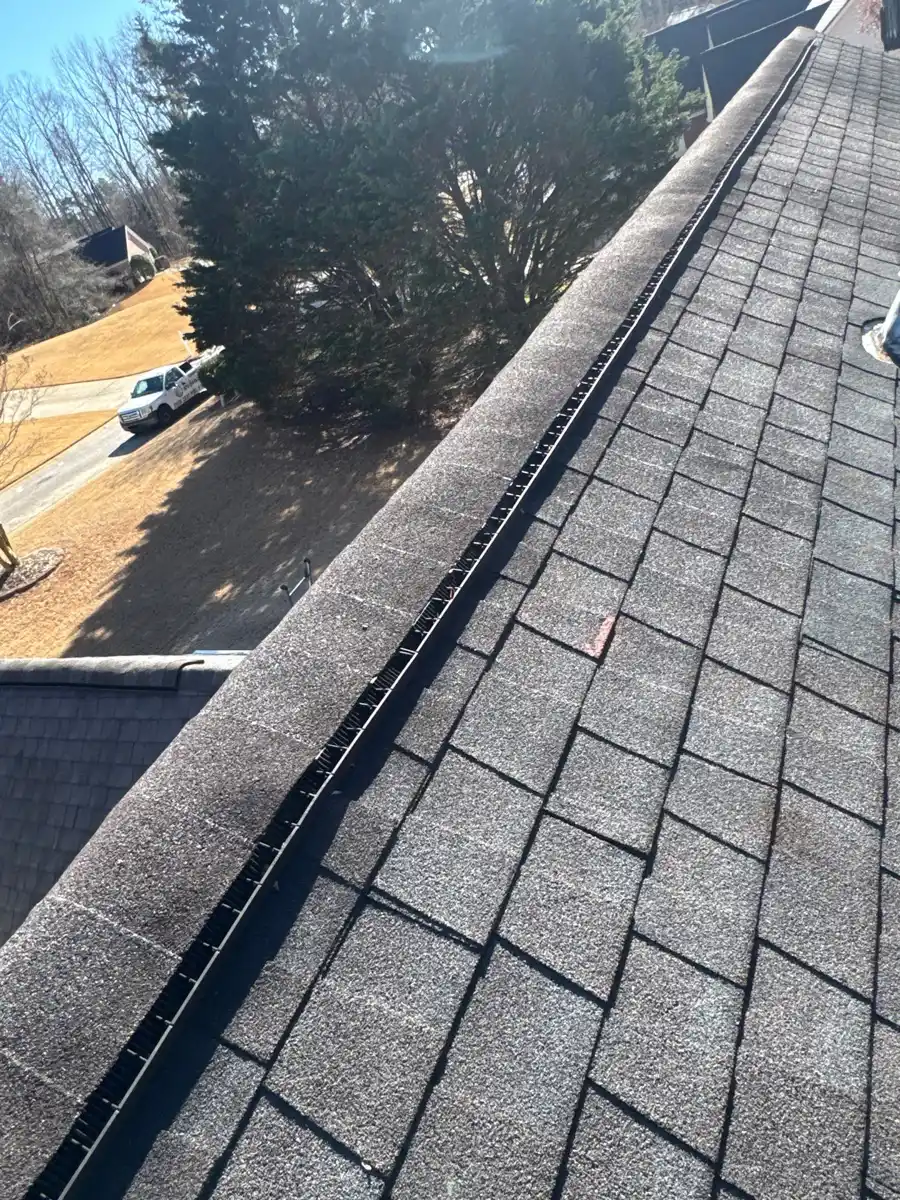 Continuous ridge vent running along gray shingle roof, Southern Premier Roofing work near Hoschton GA