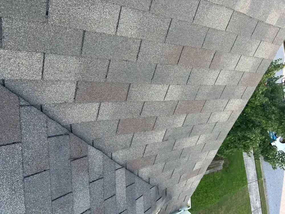 Gray shingle roof meeting adjacent siding and landscaped yard, Southern Premier Roofing work near Ila GA