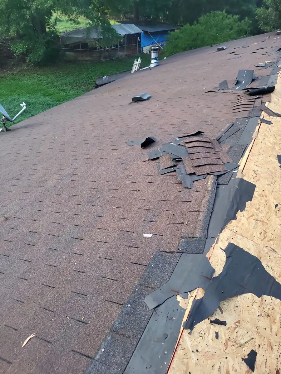 Roof shingles partially removed beside exposed roof decking, Southern Premier Roofing work near Jersey GA