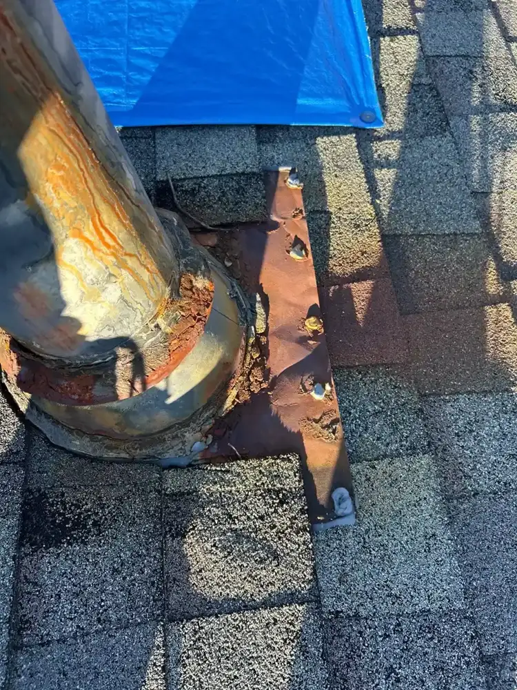 Roof flashing and shingles around vent area beneath protective tarp, Southern Premier Roofing work near Johns Creek GA