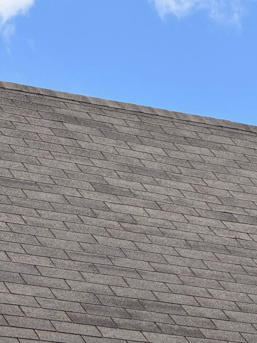 Uniform gray asphalt shingle roof slope under clear blue sky, Southern Premier Roofing work near Lawrenceville GA