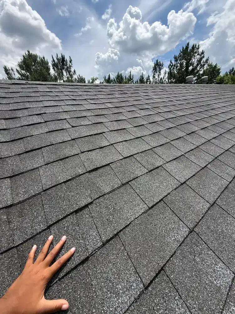 Clean completed shingle roof surface under bright cloudy sky, Southern Premier Roofing work near Lilburn GA