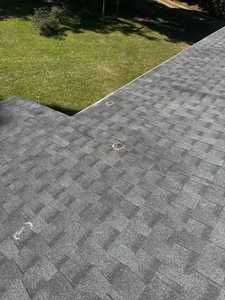 Gray asphalt shingle roof section viewed from above beside lawn, Southern Premier Roofing work near Lithonia GA