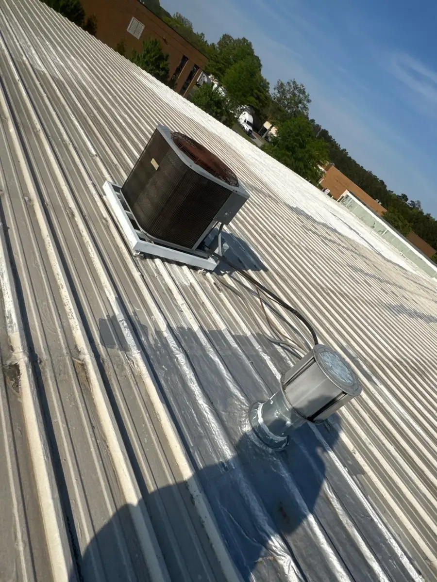 Metal roof with rooftop vent and sealed flashing detail visible, Southern Premier Roofing work near Lithonia GA