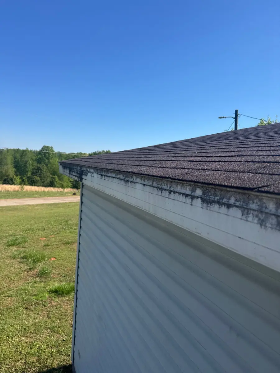 Roof edge shows weathered flashing above exterior siding, Southern Premier Roofing work near Loganville GA