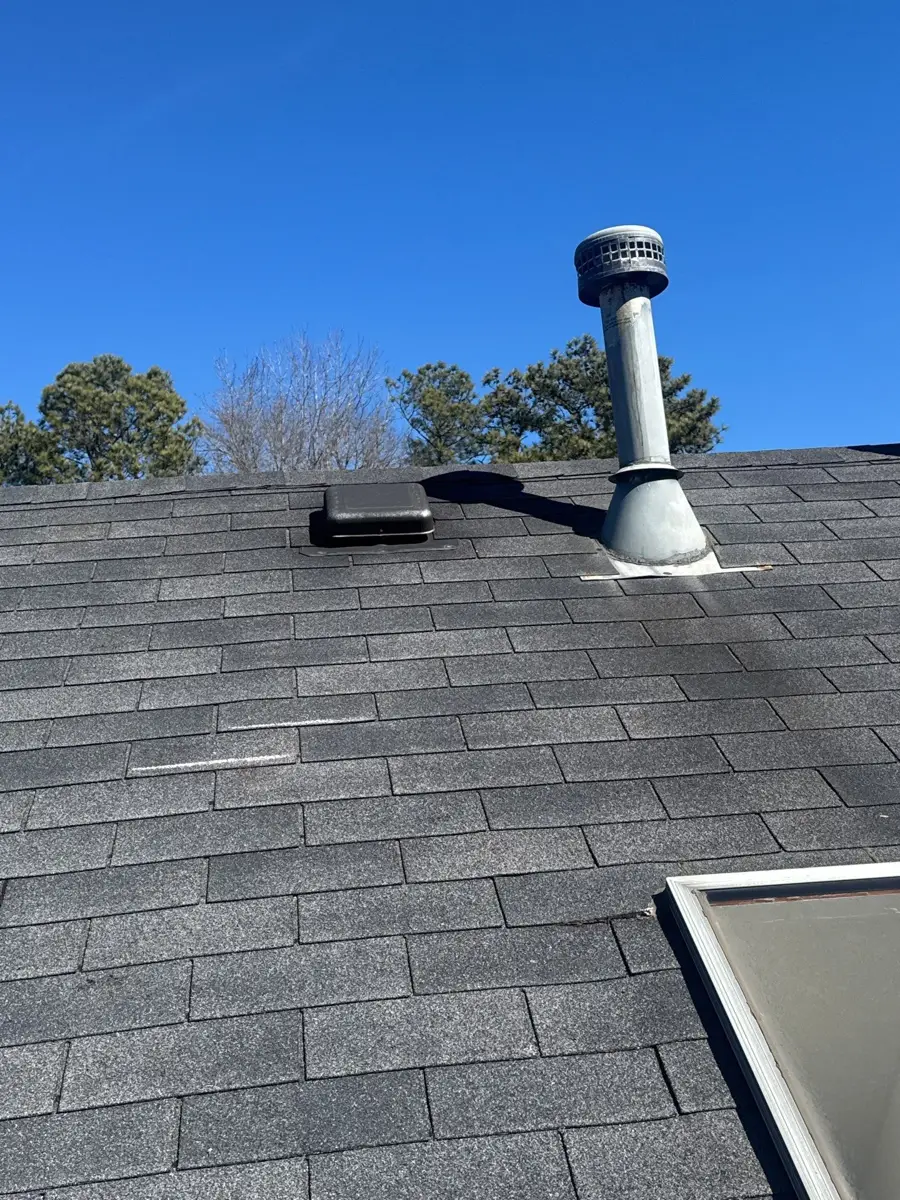 Roof shingles with metal vent pipe and skylight visible, Southern Premier Roofing work near Lula GA