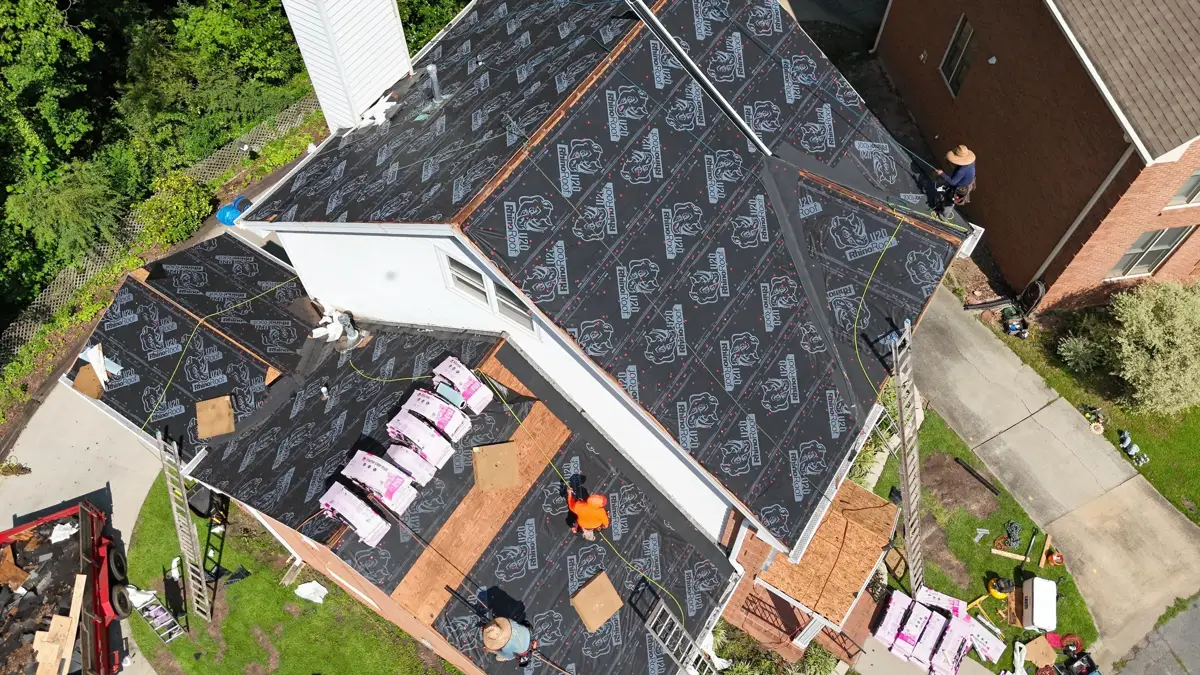 Roof covered with patterned underlayment beside exposed decking, Southern Premier Roofing work near Maysville GA