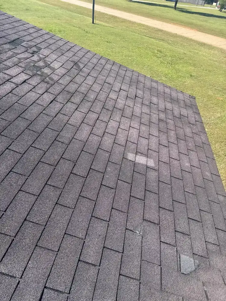 Wide view of weathered asphalt shingle roof with scattered discoloration, Southern Premier Roofing work near Monroe GA