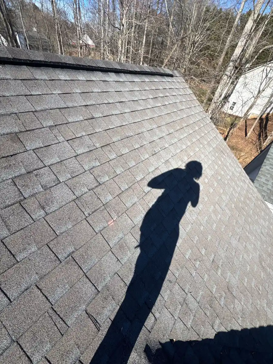 Shingle roof slope with continuous ridge vent along upper edge, Southern Premier Roofing work near Mulberry GA