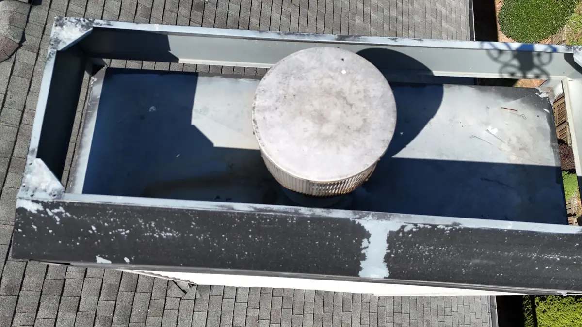 Roof opening with metal flashing, sealant, and circular rooftop fixture, Southern Premier Roofing work near Nicholson GA